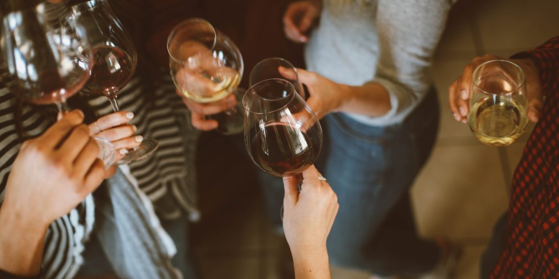 A group of women drinking wine and cheering