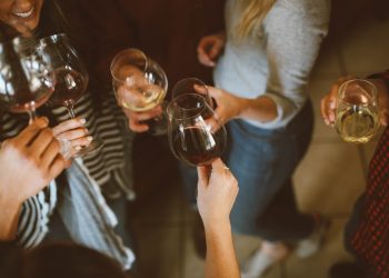 A group of women drinking wine and cheering